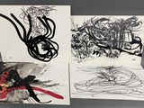three black and white cards with drawings on them sitting on a table