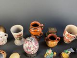 many different types of vases sitting on a table