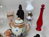 many different vases and glass items on the table