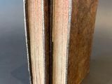 three books are stacked on top of each other on a table