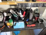 a black counter top with a bunch of kitchen utensils on it