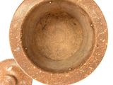 an old mortar with a lid on a white background