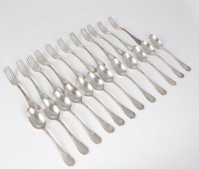 a lot of silver spoons and forks on the table