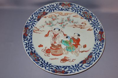 a plate with a painting on it sitting on a table