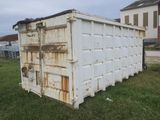 a white container sitting in the middle of a field