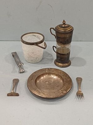 a silver plate and silverware on a white table