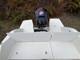a white boat with a motor on the back of it