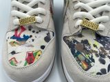 someone is wearing a pair of white shoes with colorful designs on them