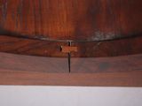 a close up of a wooden shelf with a clock on it