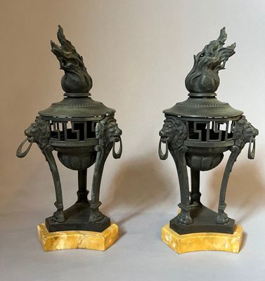 two bronze statues of a dragon on top of each other