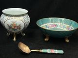 two bowls and a spoon sitting next to each other