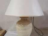 a lamp that is sitting on a table with a lamp shade on it
