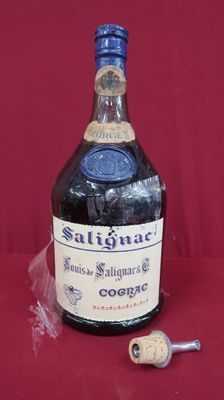 a bottle of liquor sitting on a table with a cork stopper