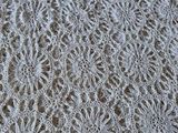 lacy white crocheted lace on a table cloth