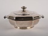 an antique silverplated casserole dish with a lid on a white background