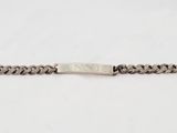 a close up of a silver chain bracelet on a white background