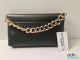 a close up of a black purse with a gold chain on it