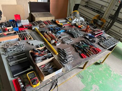 une table sur laquelle sont posés de nombreux outils, dans un garage
