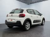 the rear end of a white citrole parked in a garage