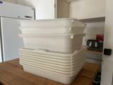 a stack of plastic containers sitting on top of a kitchen counter