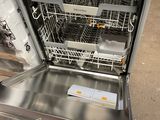 a dishwasher that is open on the floor