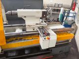 a machine that is working on a piece of wood