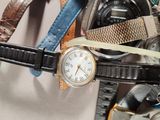 a lot of watches that are stacked together on a table