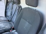 four seats in the back of a van that are covered in black cloth