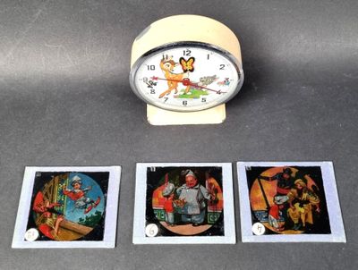 a clock that is sitting on a table next to four pictures