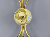 gold metal wall sconce with five brass spoons and a glass bowl