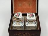 two salt and pepper shakers in a wooden box
