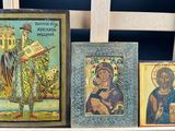 three framed pictures of jesus and other religious items on a chair