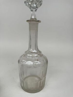 a glass bottle with a stopper on top of it