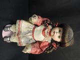 a doll that is sitting on a black surface