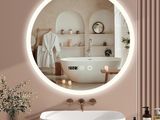 a bathroom with a bathtub and a mirror on the wall