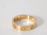 an image of a gold ring on a white surface