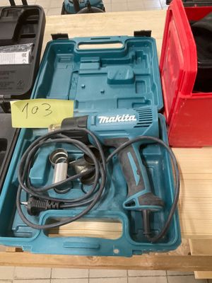 une boîte à outils bleue contenant une perceuse filaire et d'autres outils