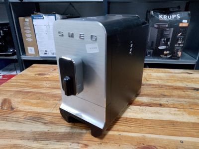 an image of a coffee machine on a wooden table