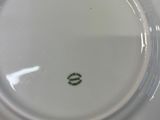 a white plate with a green design on it