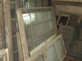 many old windows that are sitting in a room