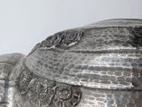 a silver box with a lid that has a flower design on it