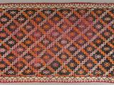 an old rug with a colorful design on it