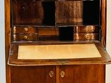 a small wooden cabinet with a drawer on top of it