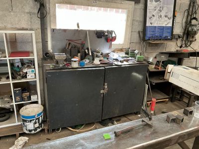 une photo d'un établi dans un atelier, avec des outils