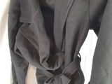 the jacket is black and has a tie around the waist