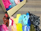 a box full of clothes sitting on a wooden floor