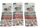 three bags of complete cruncher dog treats on a white background