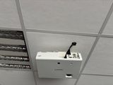 a white box on the ceiling with wires attached to it