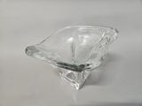 a clear glass bowl with a spoon in it