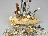 a pile of pins and needles sitting on top of a rock